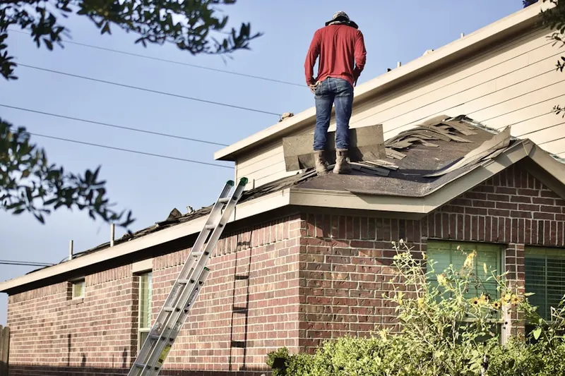 Professional roofer working on a residential roof in Manassas Park